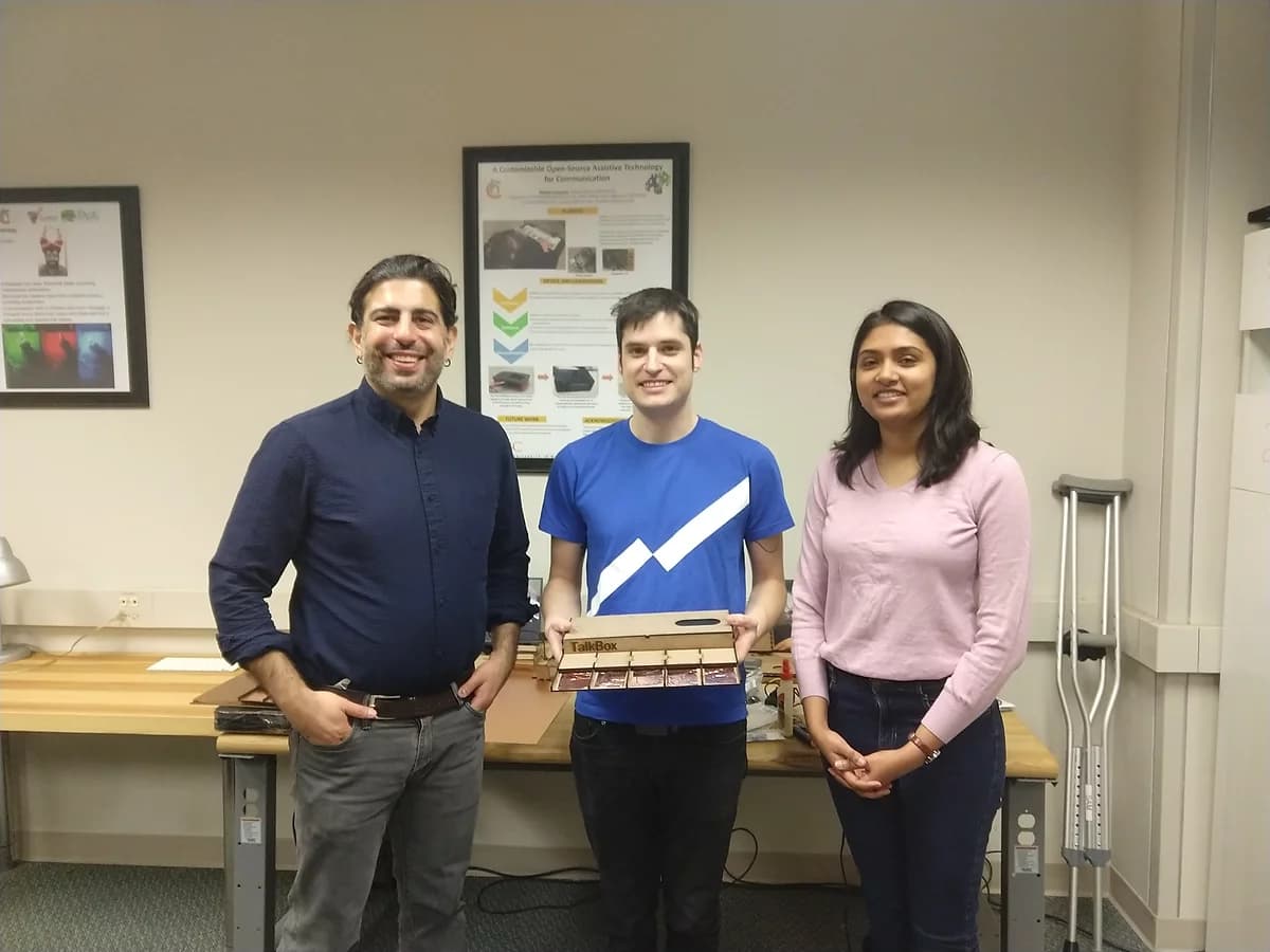 Left to right: Dr. Foad Hamidi, Jason Charney (holding TalkBox), and I in the DARE Lab.